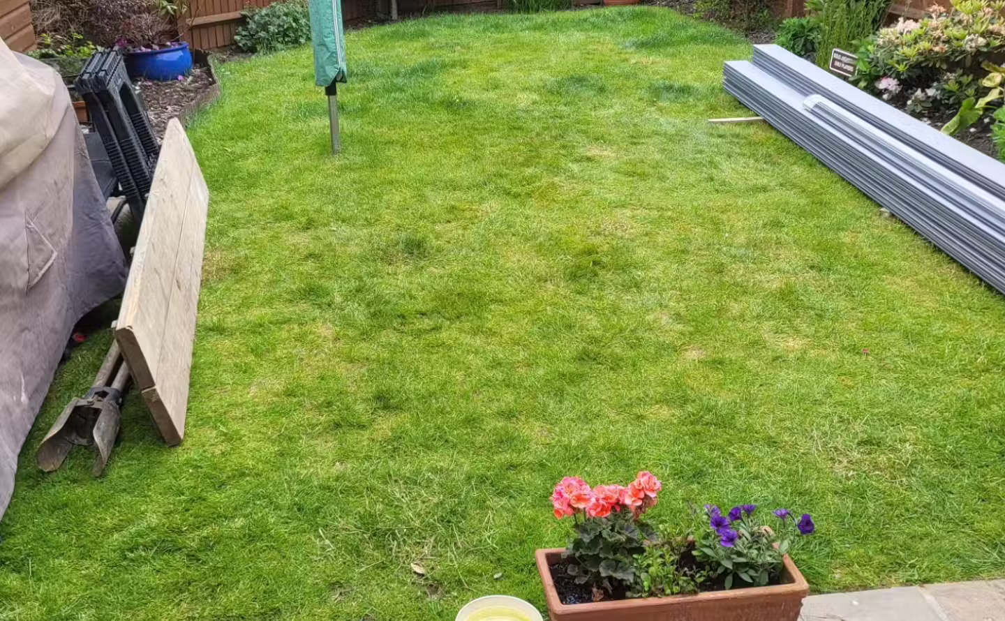 Tired garden lawn and patio space before landscaping transformation in West Sussex