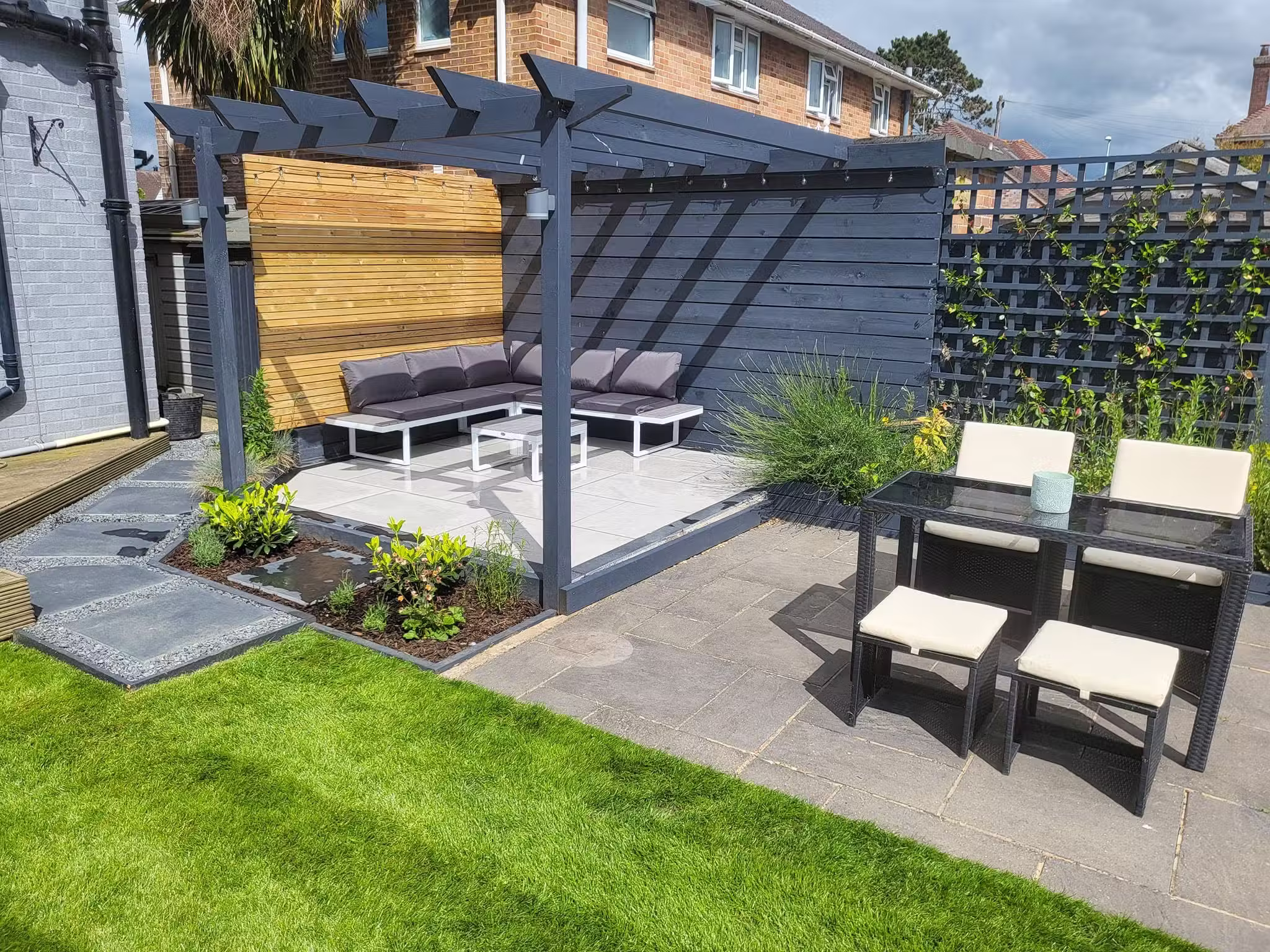 New garden patio with pergola seating area after landscaping in Worthing, West Sussex