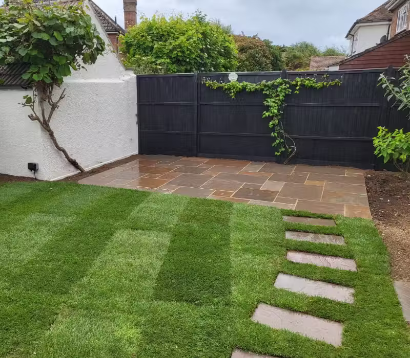 Garden build featuring turfing, a laid path, patio and fencing in Surrey by Casteldine Landscapes