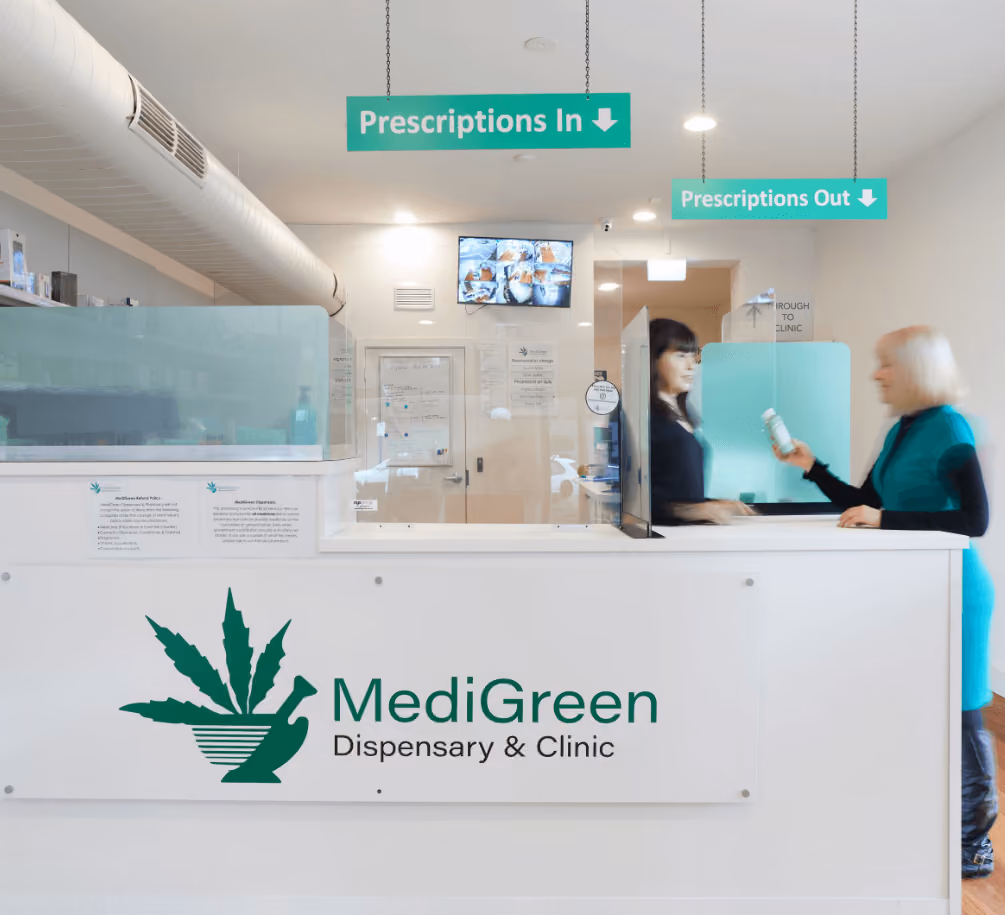 Medigreen Dispensary clinic front counter with patient receiving medicines