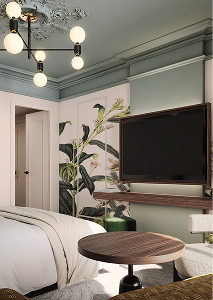 Quarto moderno com parede verde, plantas decorativas, TV montada na parede e mesa redonda de madeira.