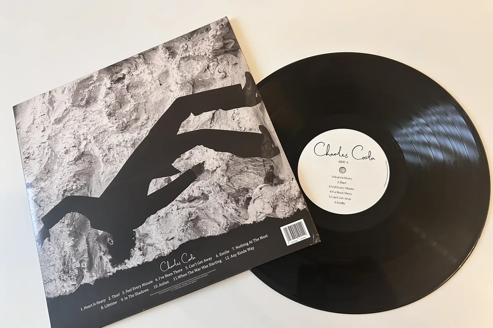 Black vinyl record pressed by AGR on its printed inner sleeve