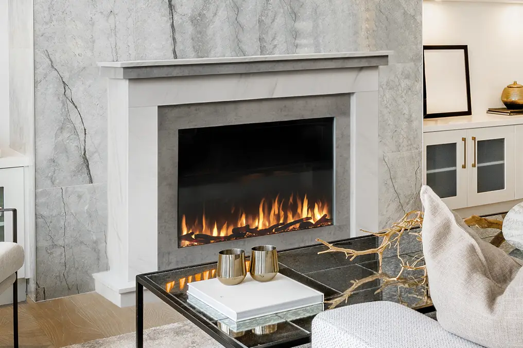 Modern fireplace with flames inside marble surround in a stylish living room setting.
