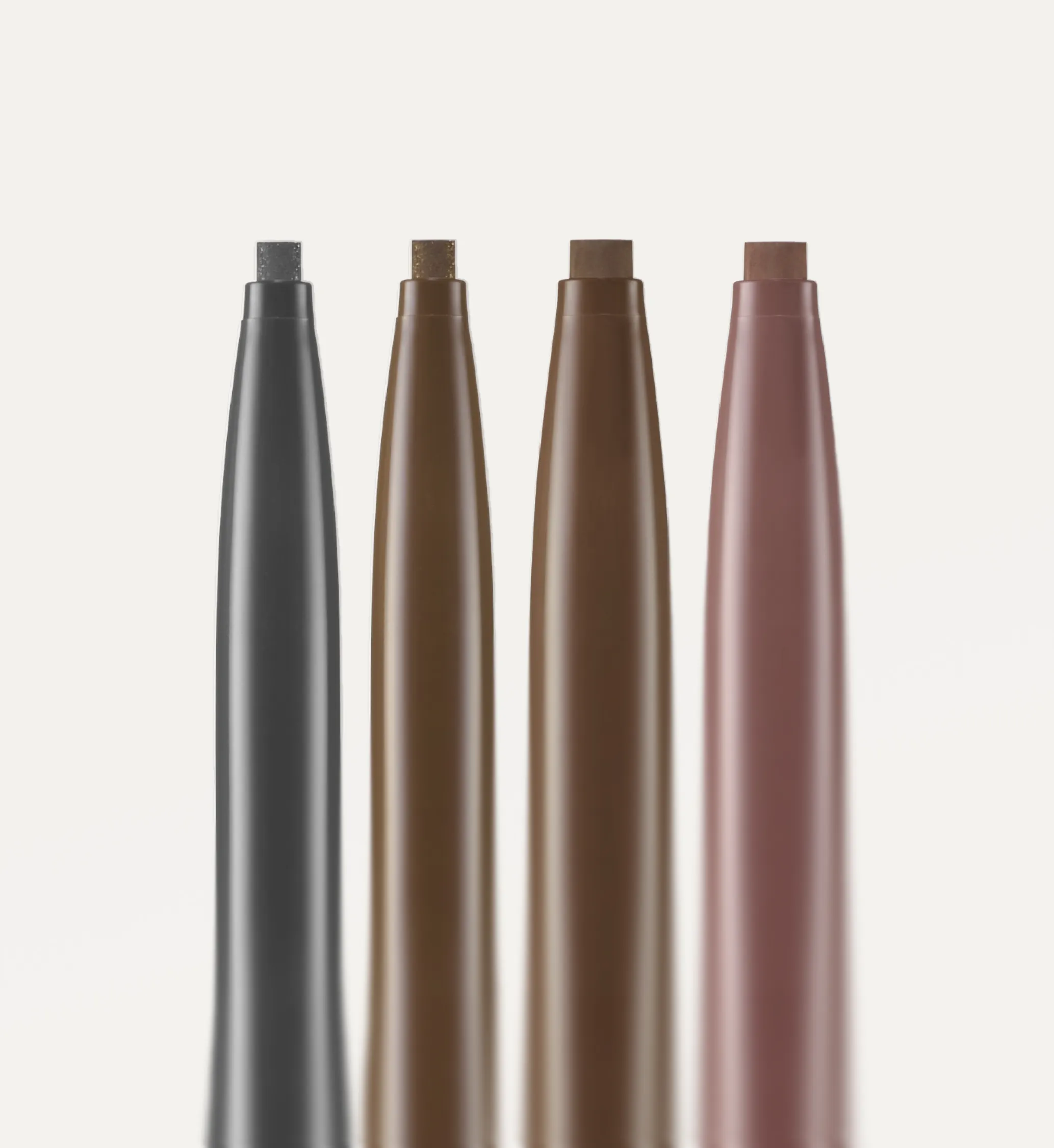 Four vertical makeup eyeliners pencils in shades of gray, gold brown, dark brown, and mauve pink on white.
