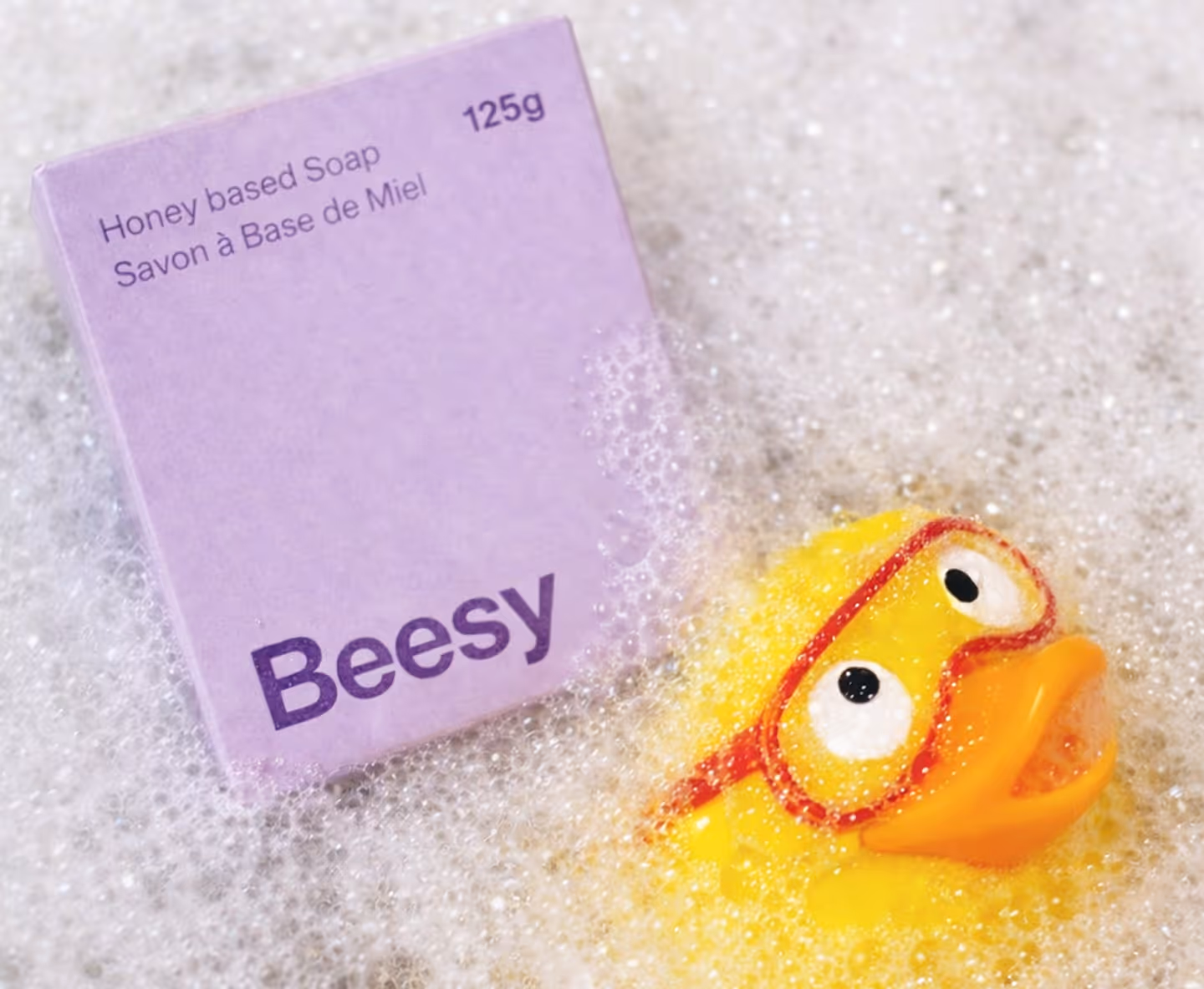 Beesy packaging in bubble bath, with goofy rubber ducky.