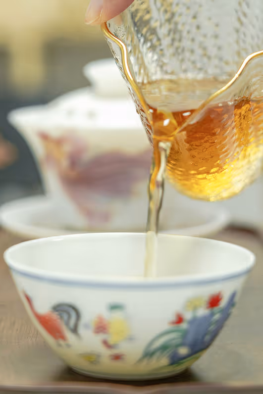 Tea being poured in teacup