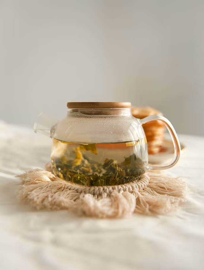 Clear teapot with tea brewing