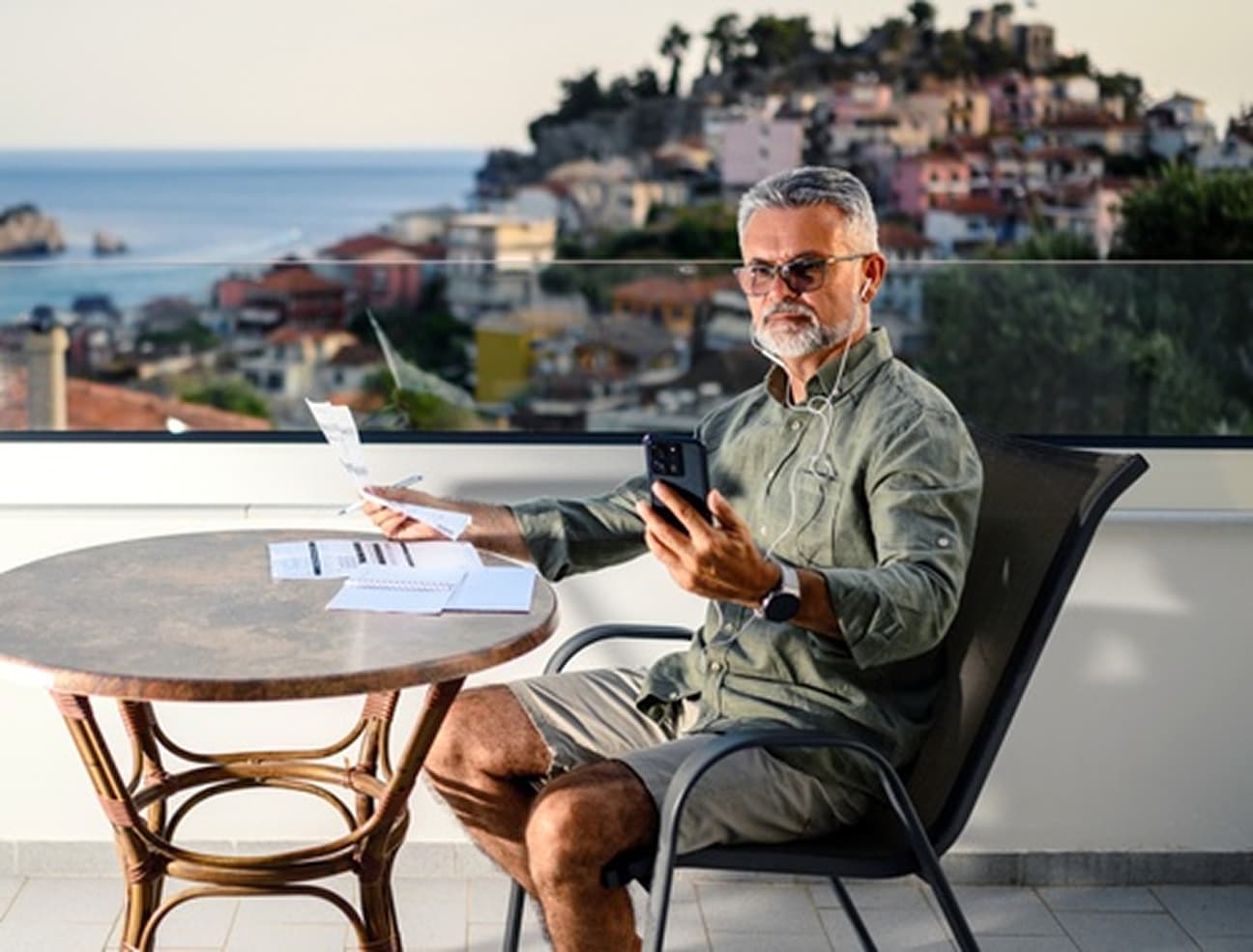 Investor reviewing documents on a balcony