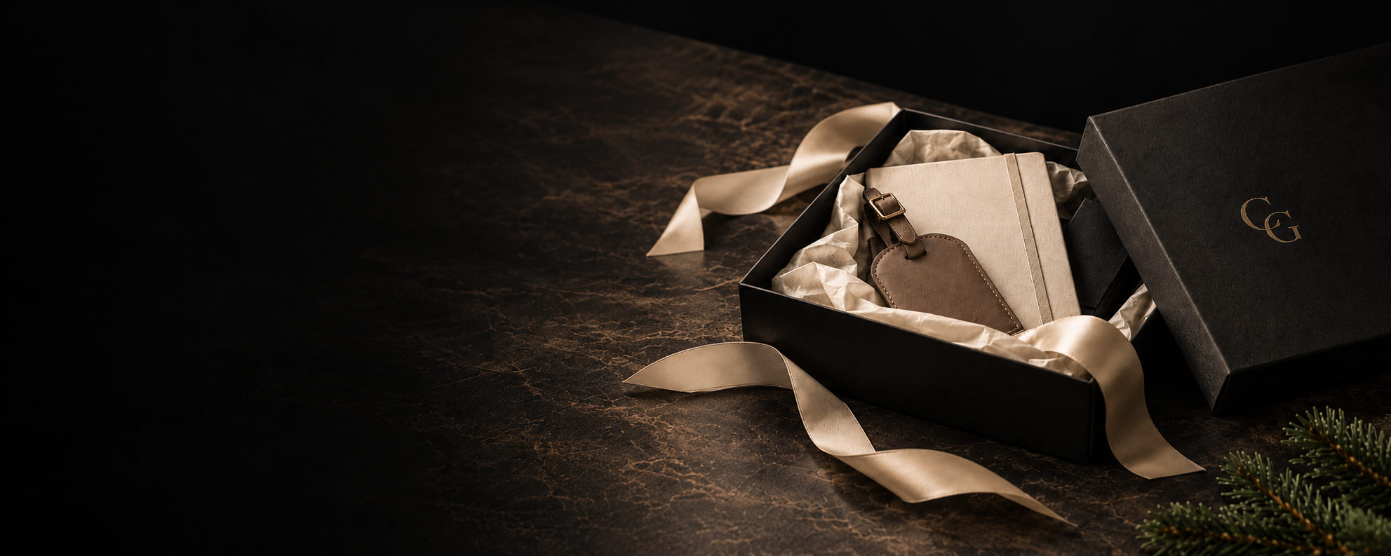 Holiday gift box with ribbon, notebook and luggage tag