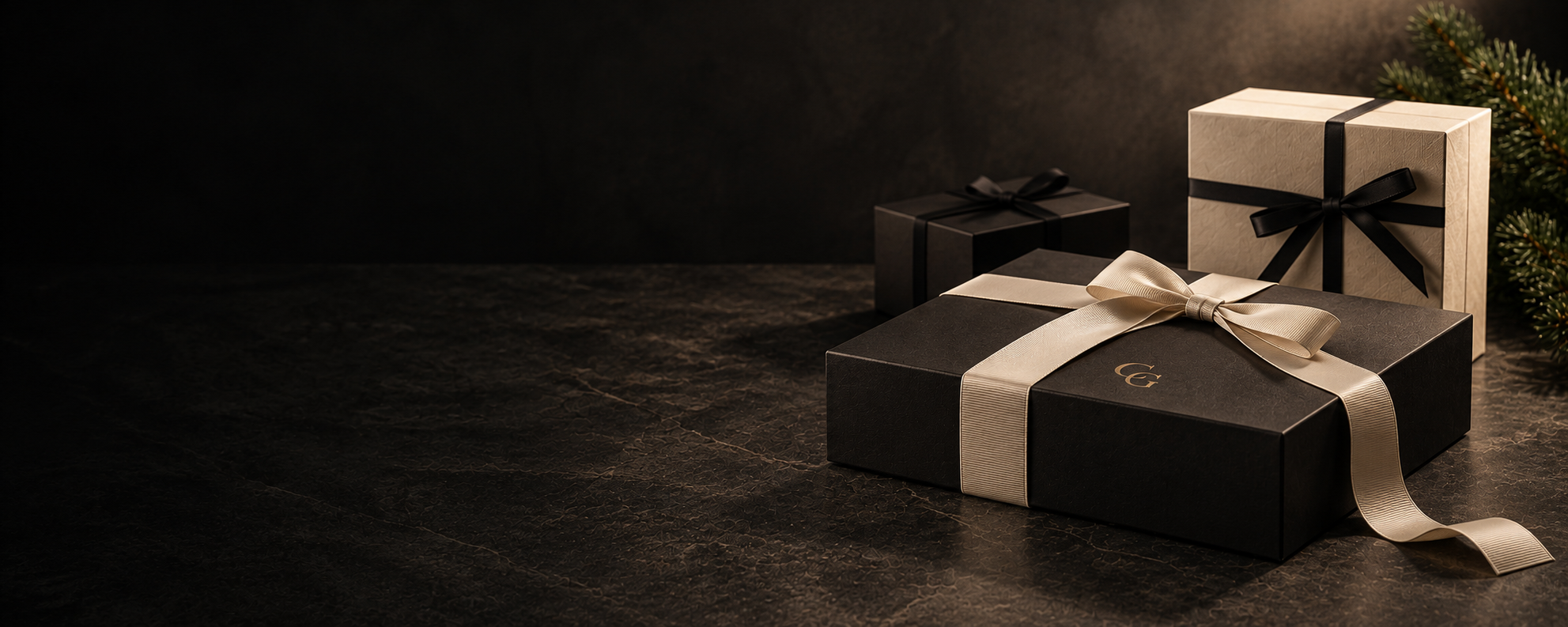 Black Capital Gifts gift box tied with a cream ribbon, beside a cream and a black gift box