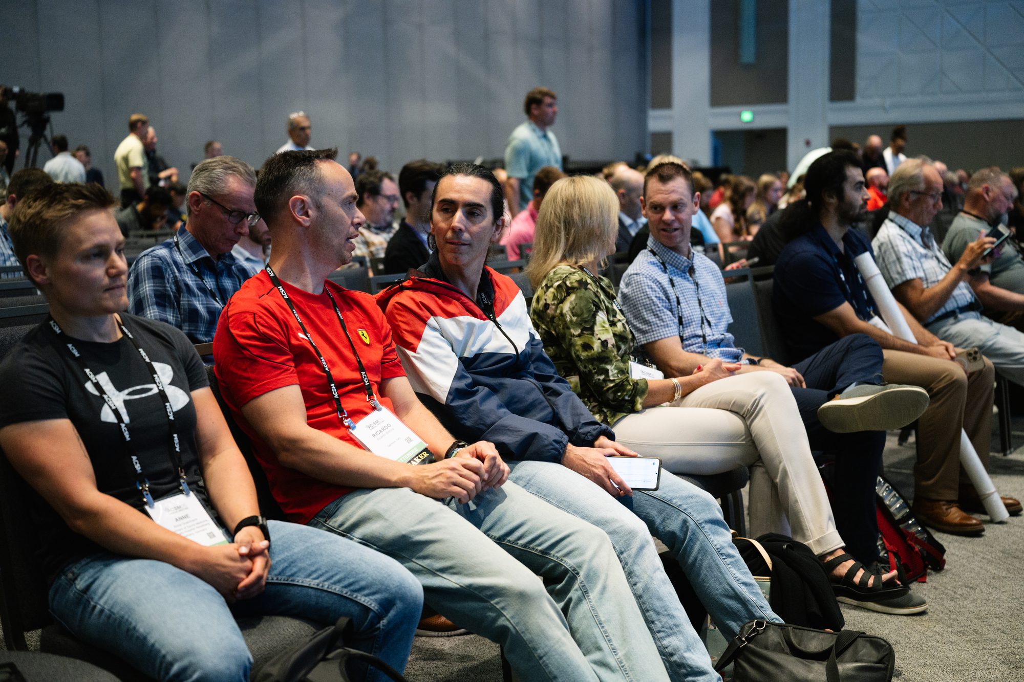 Row of conference attendees watching a session presentation