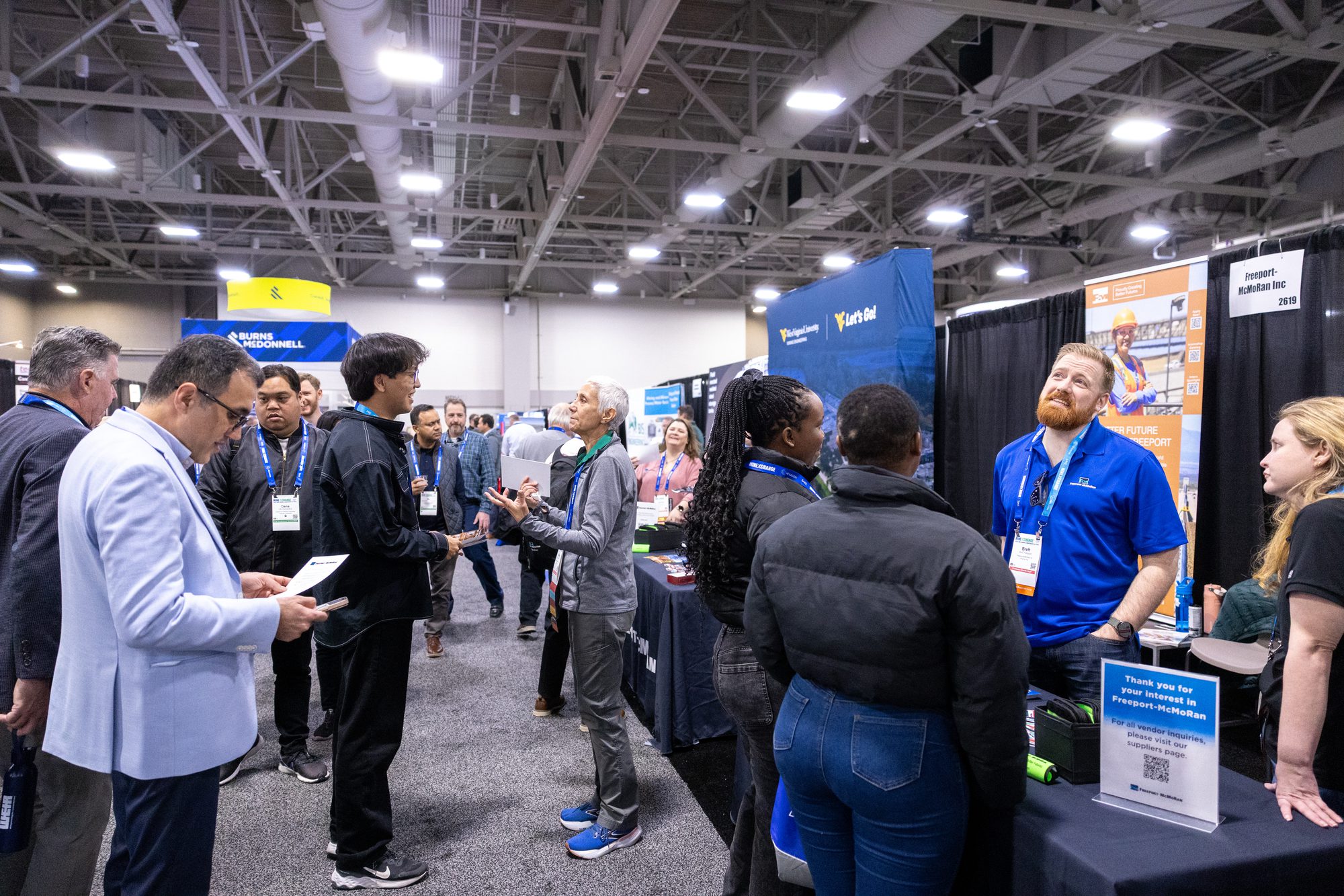 Busy association expo floor with attendees and exhibitor booths