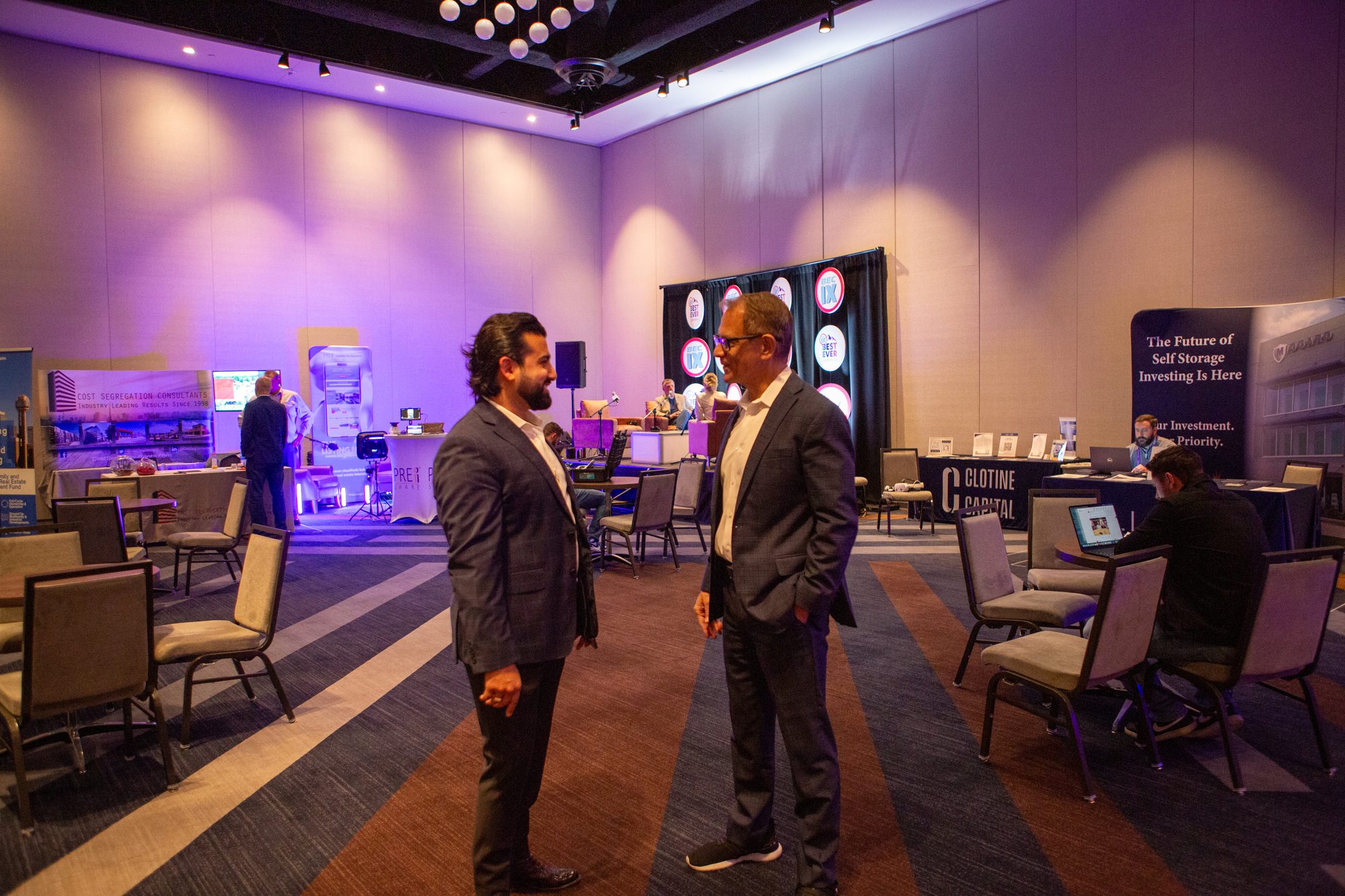 Two attendees talking in a conference networking lounge