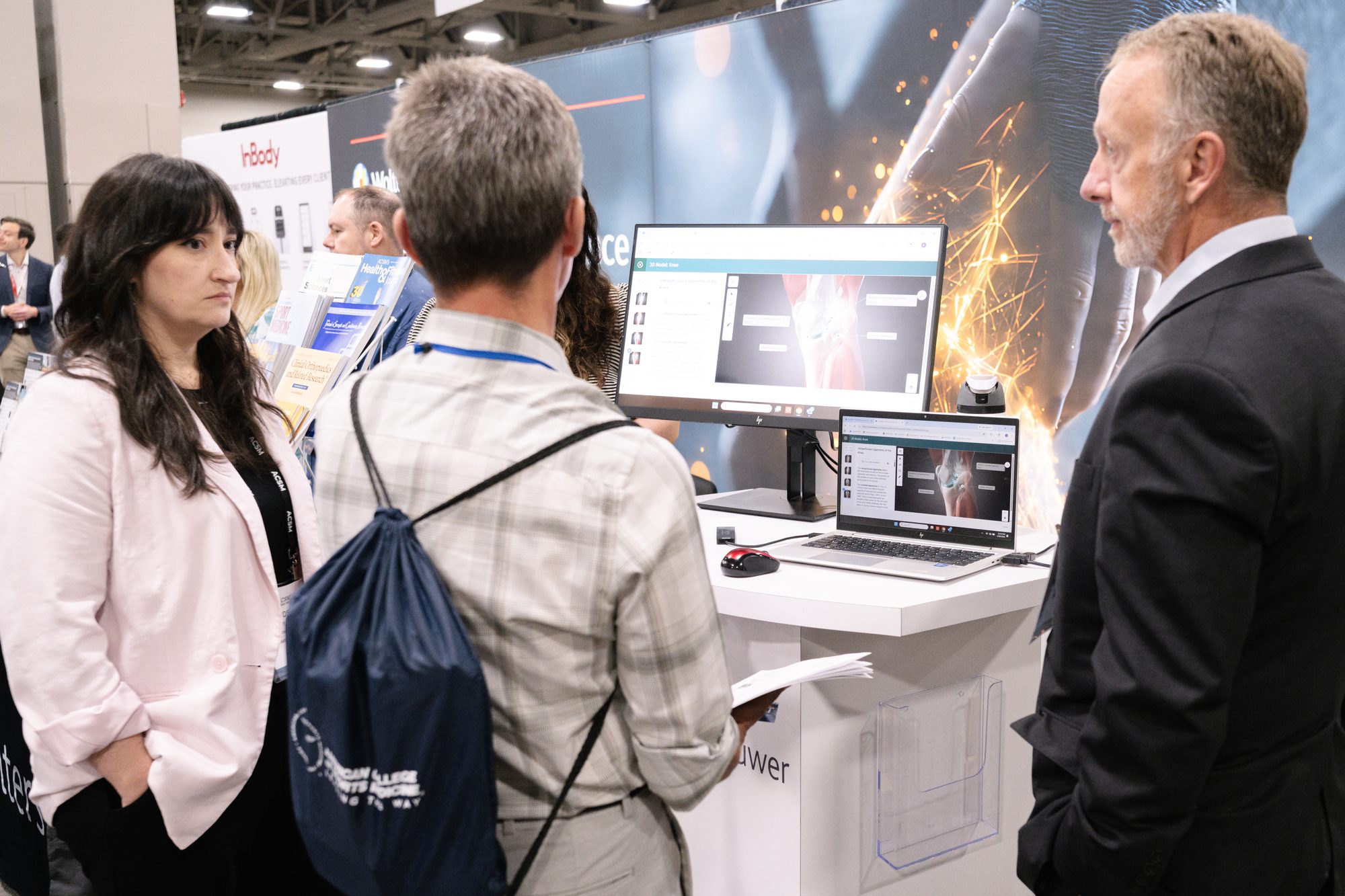 Exhibitor showing software to attendees at a conference booth