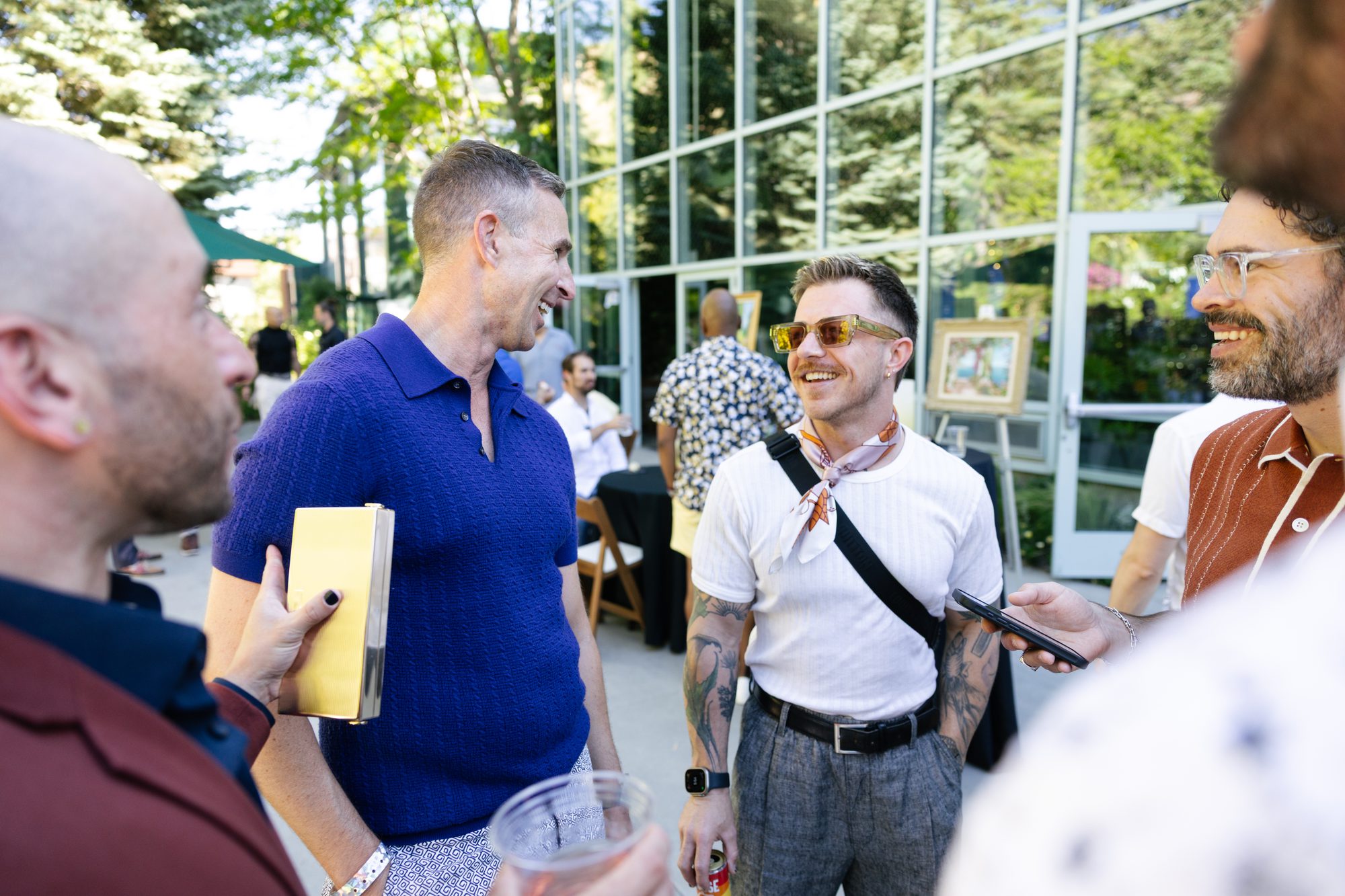 Guests laughing together at an outdoor reception