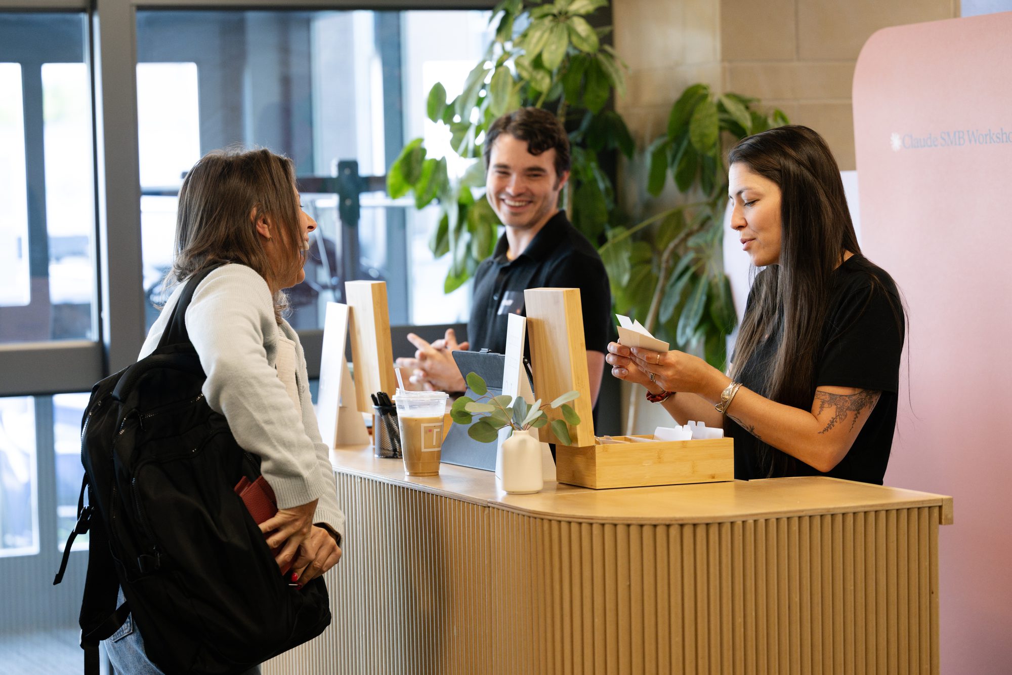 Staff greeting guests at an event registration counter