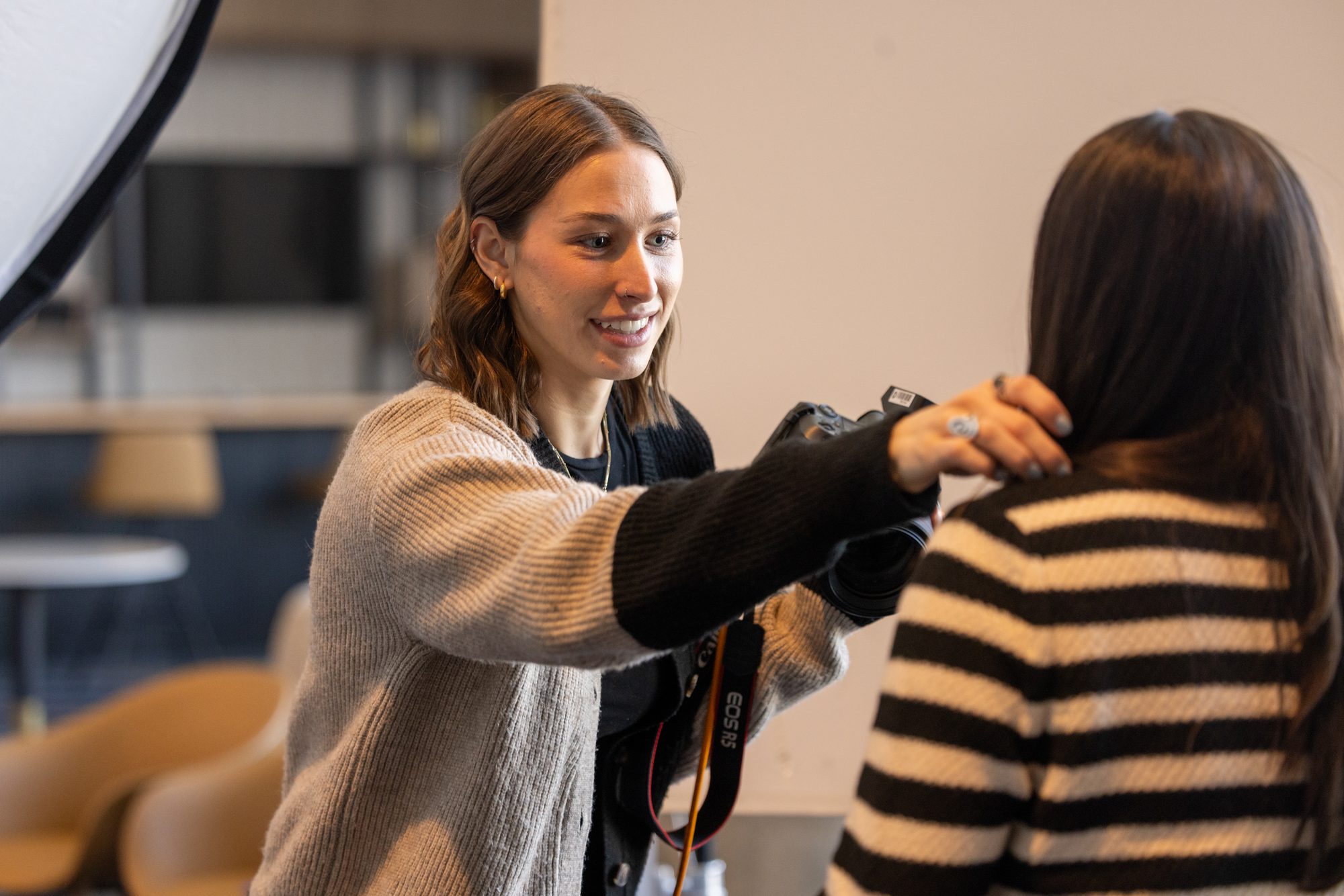 Photographer shooting an on-site professional headshot with studio lighting at a conference
