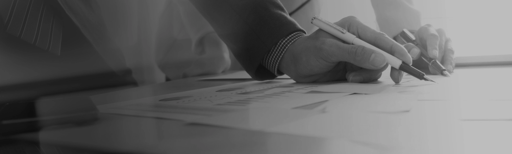hands pointing at document with pens