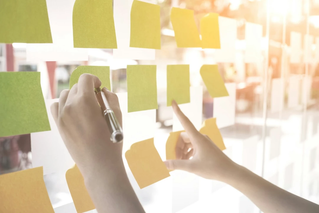 pointing at sticky notes on window