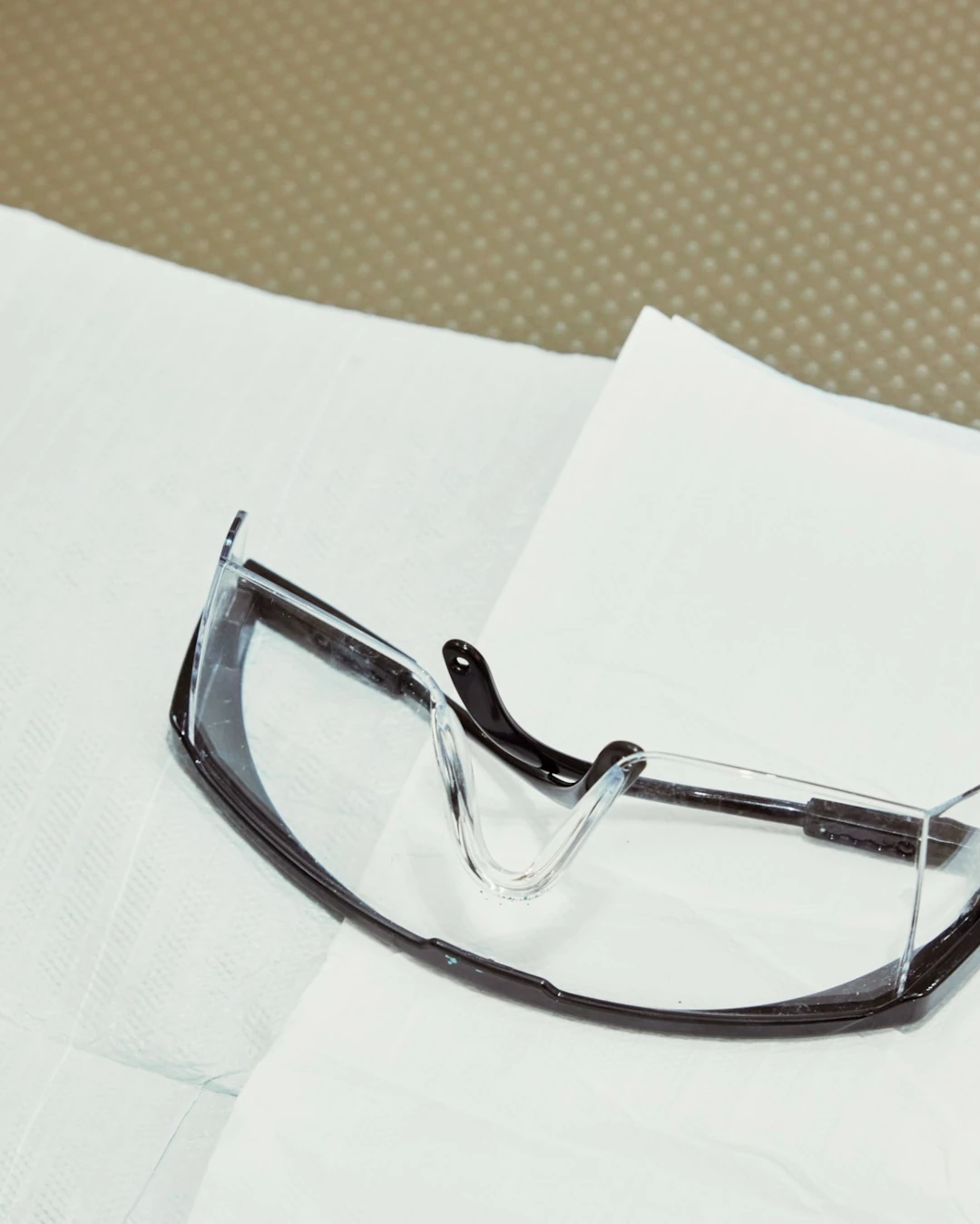 safety glasses laying on table