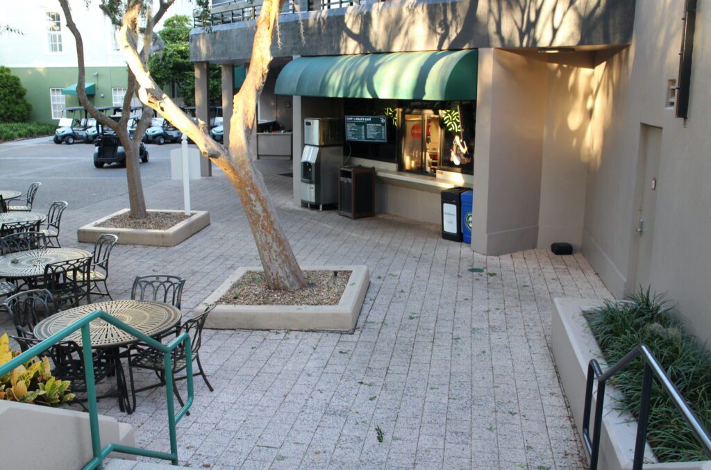 An outdoor food window with a green canopy covering 