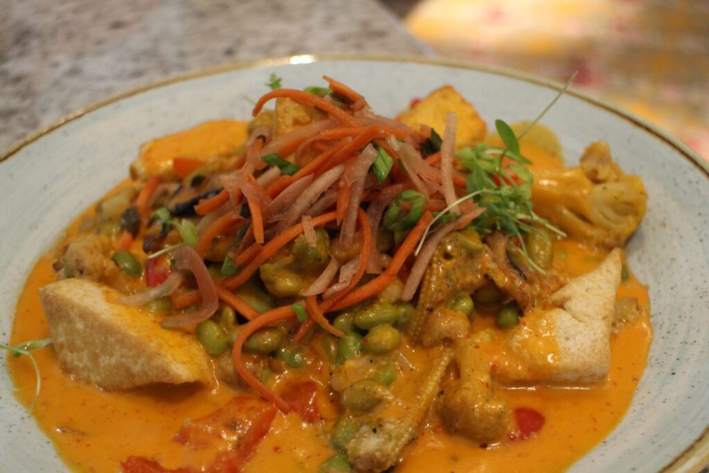an orange curry dish with vegetables and tofu at one of the Grand Floridian restaurants