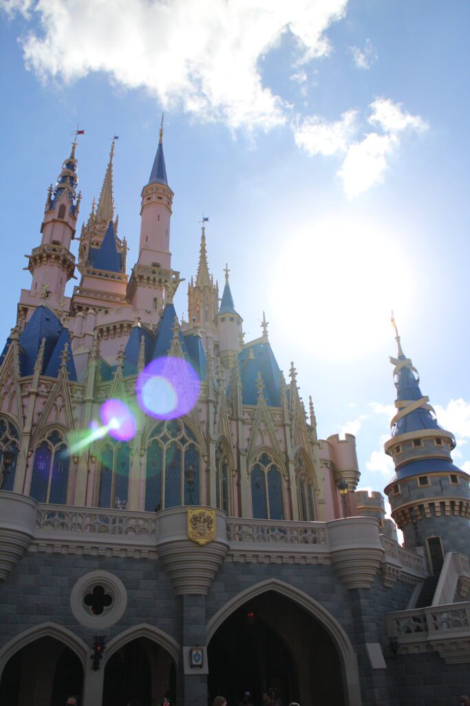 a solar flare sparkles over the top of Cinderella castle