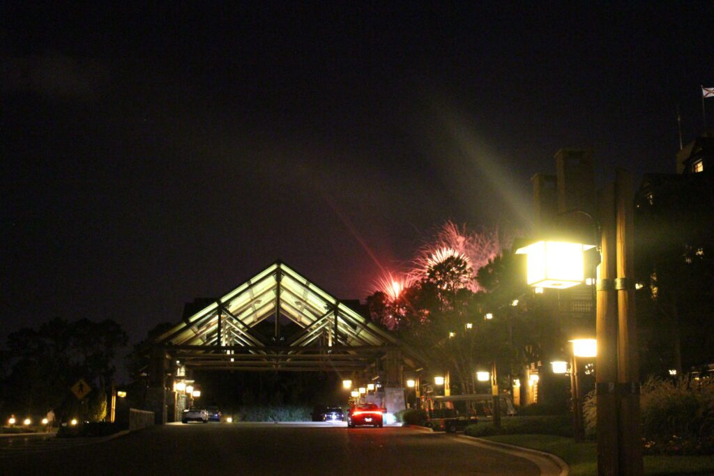 Wilderness Lodge porte cochere and fireworks going off through the trees.