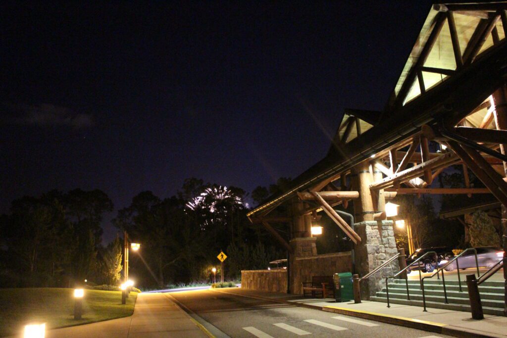 Wilderness Lodge porte cochere and fireworks going off through the trees.
