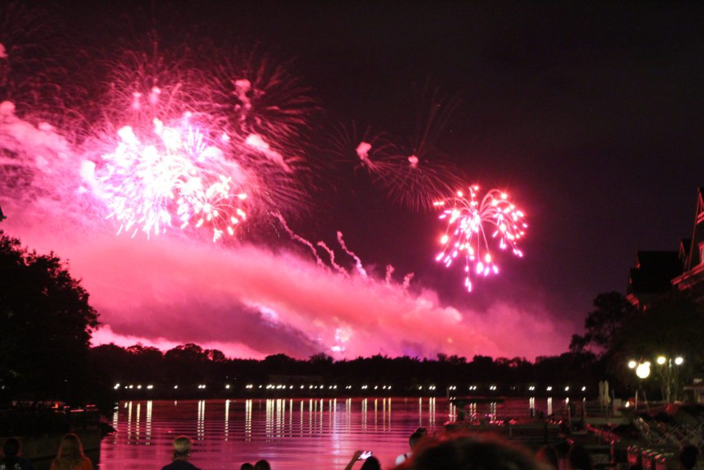 Grand Floridian firework view from marina with red fireworks and smoke.