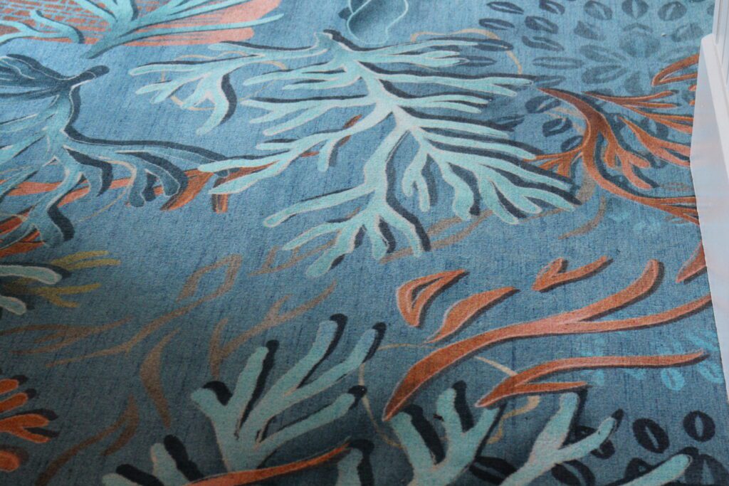 blue carpet with pieces of light blue and coral colored coral