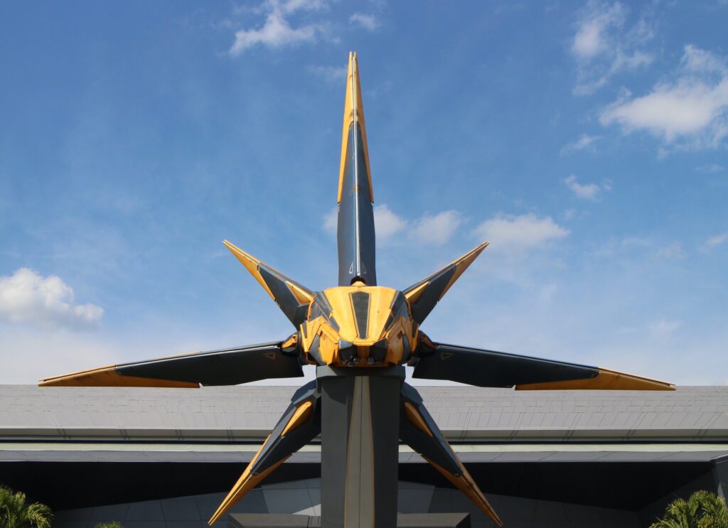 Disney Annual Pass 2023 Price A space ship hovers in front of a blue sky in front of the Guardian attraction