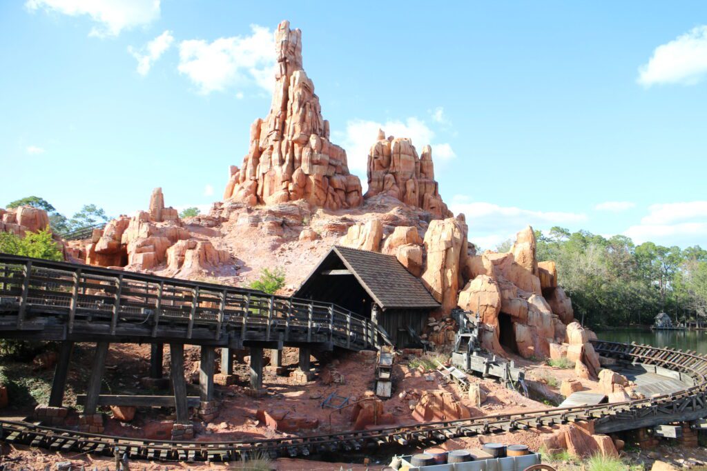 A rustic rock mountain with a train track around it
