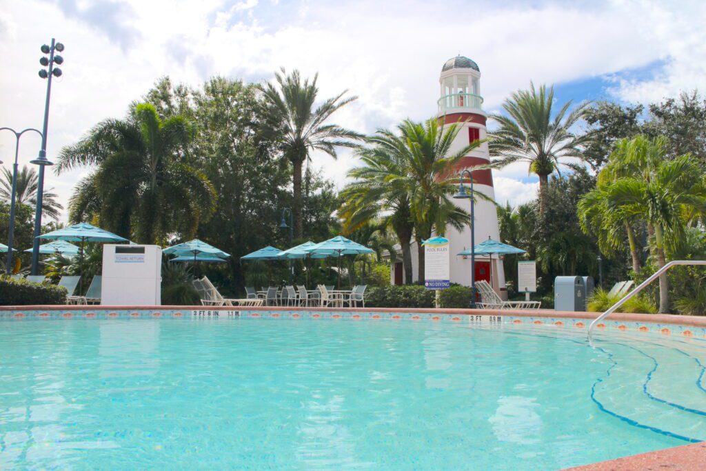 teal pool water near a decorative lighthouse
