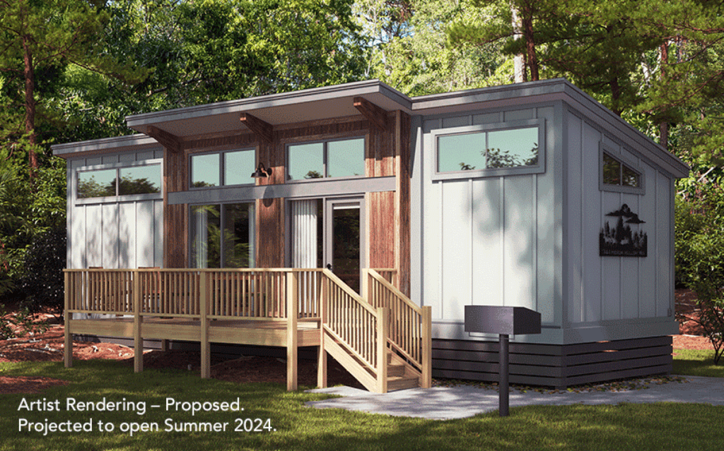 A cabin with a modern aesthetic stands in the woods
