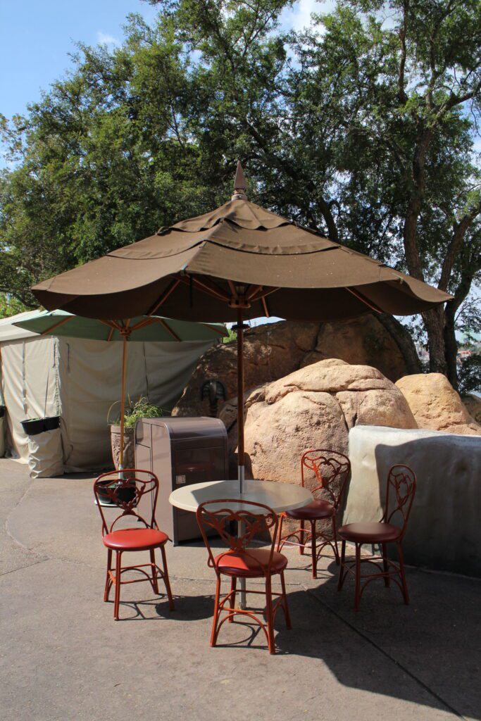 Table and chairs under an umbrella in World Showcase at Epcot
