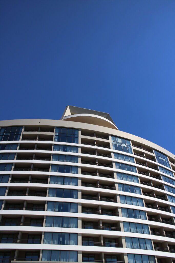 Stories tall exterior of Bay Lake Tower building against a blue sky
