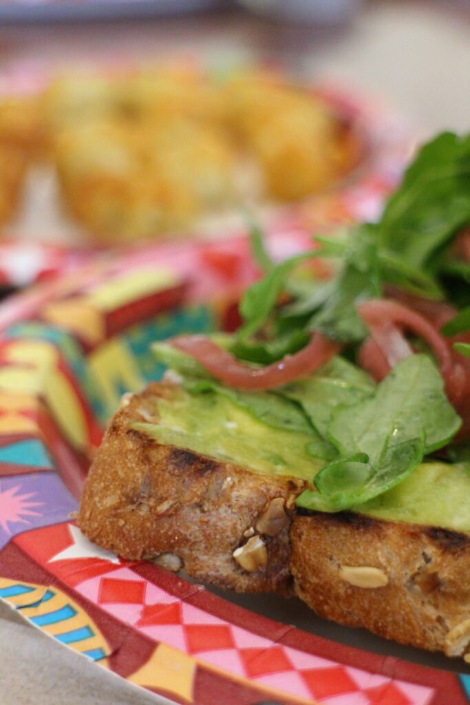 Avocado toast with greens on a colorful Disney plate