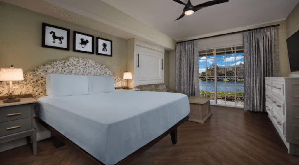 Deluxe Studio room with one bed and a living room type space in front of a window with a lake view