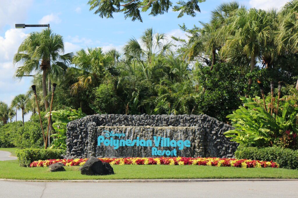 lushly landscaped rock work entrance sign that says Disney's Polynesian Village Resort