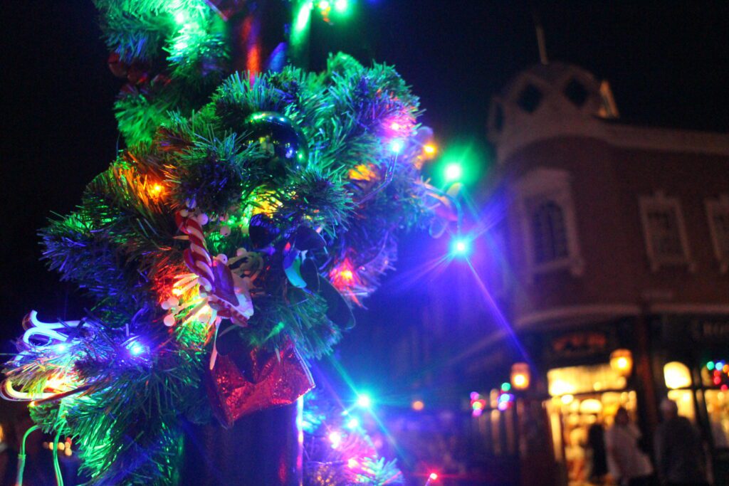 A garland and lights wrapped on a pole in the U.K. pavilion at Epcot