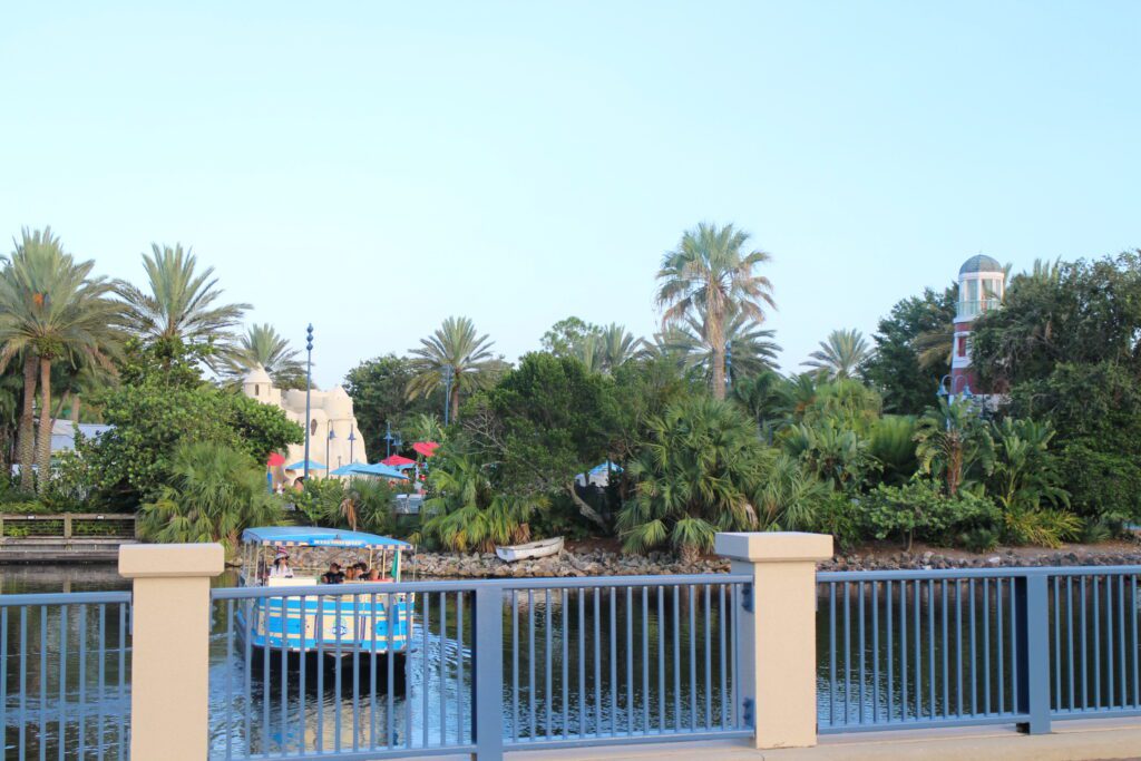 Beyond the railing of a bridge, a taxi boat cruises away in the Disney's Old Key West Resort waterway.