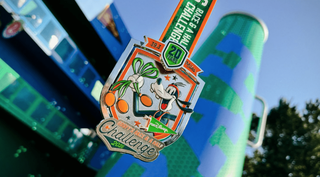 The 2025 Goofy Challenge medal with a design of Goofy holding three medals on it.