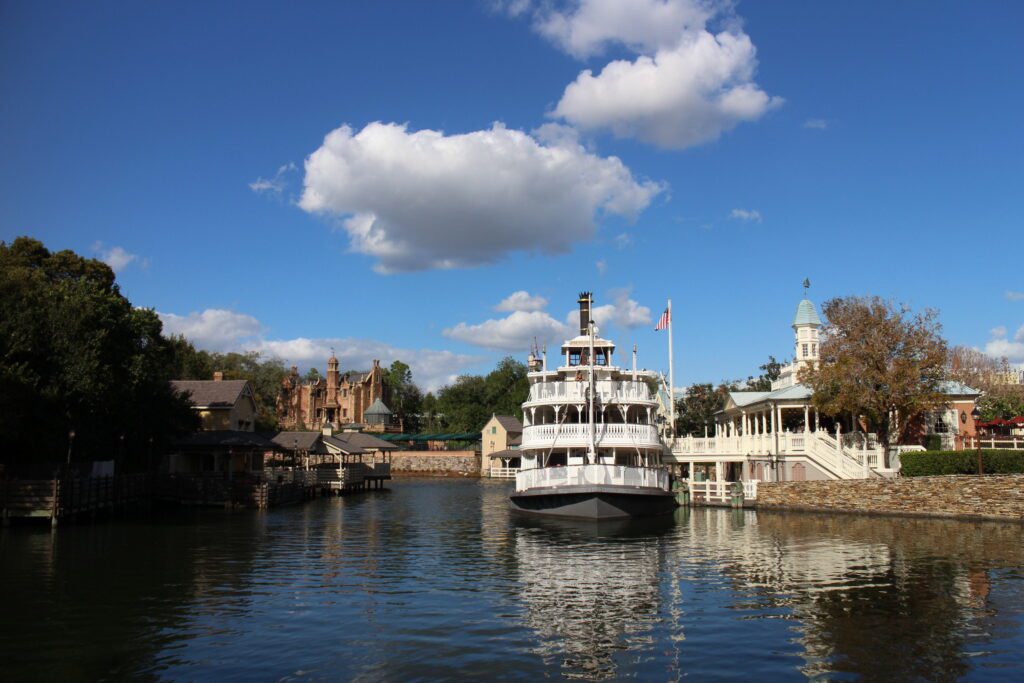 A steam boat on a lake under a blue sky