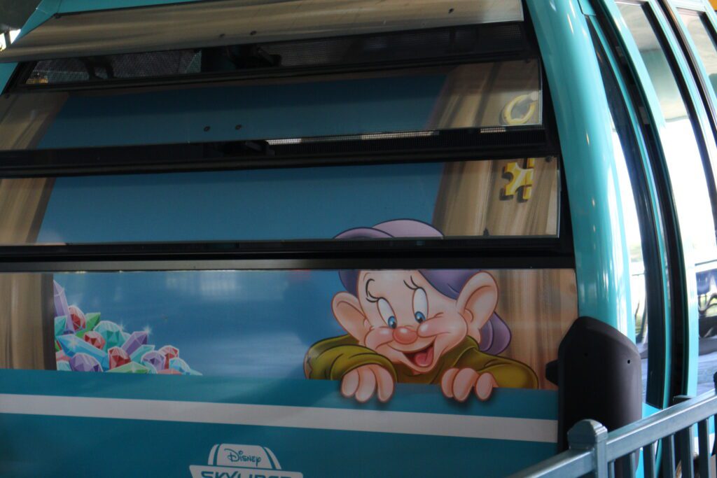 Dopey on a Disney Skyliner gondola  window.