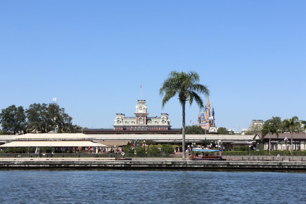 The front of Magic Kingdom showing the monorail beam, train station and boat launches.