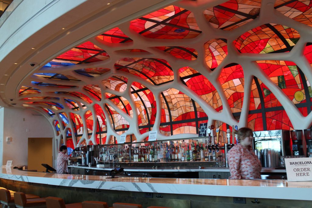 A red mosaic wall behind the Barcelona Lounge bar and lounge at Disney World.