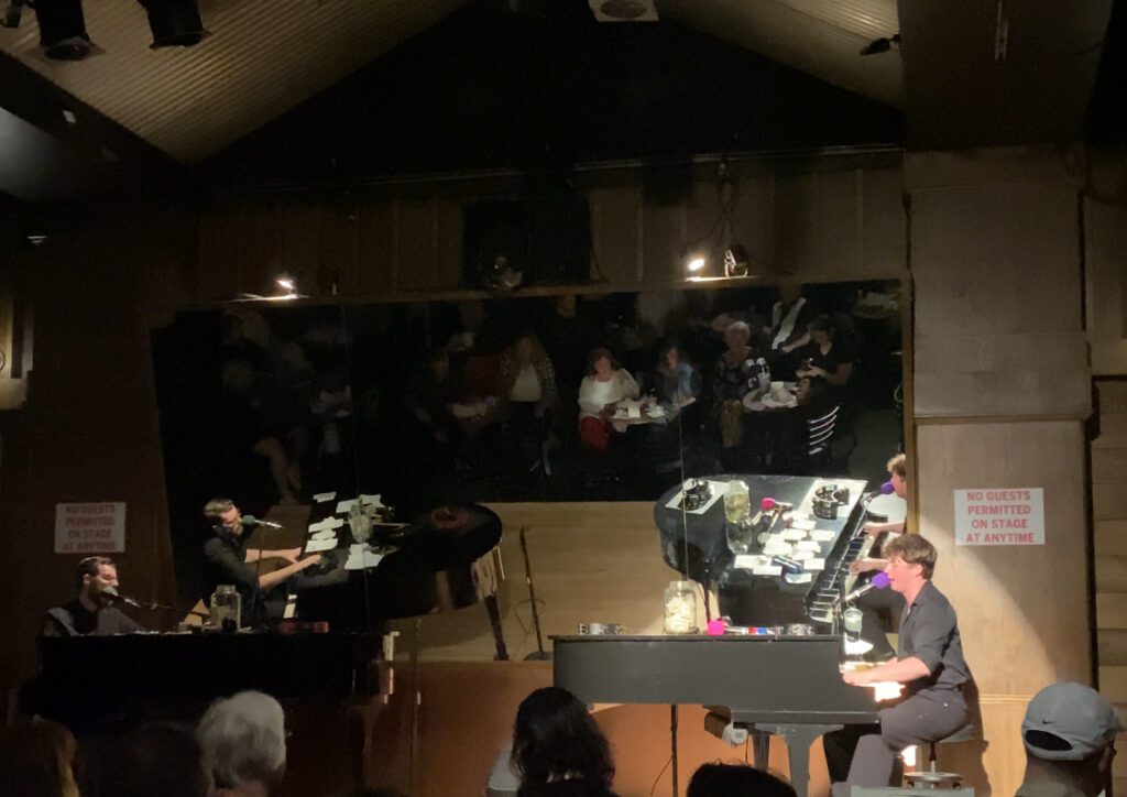 Jellyrolls dueling piano bar with performers on stage.