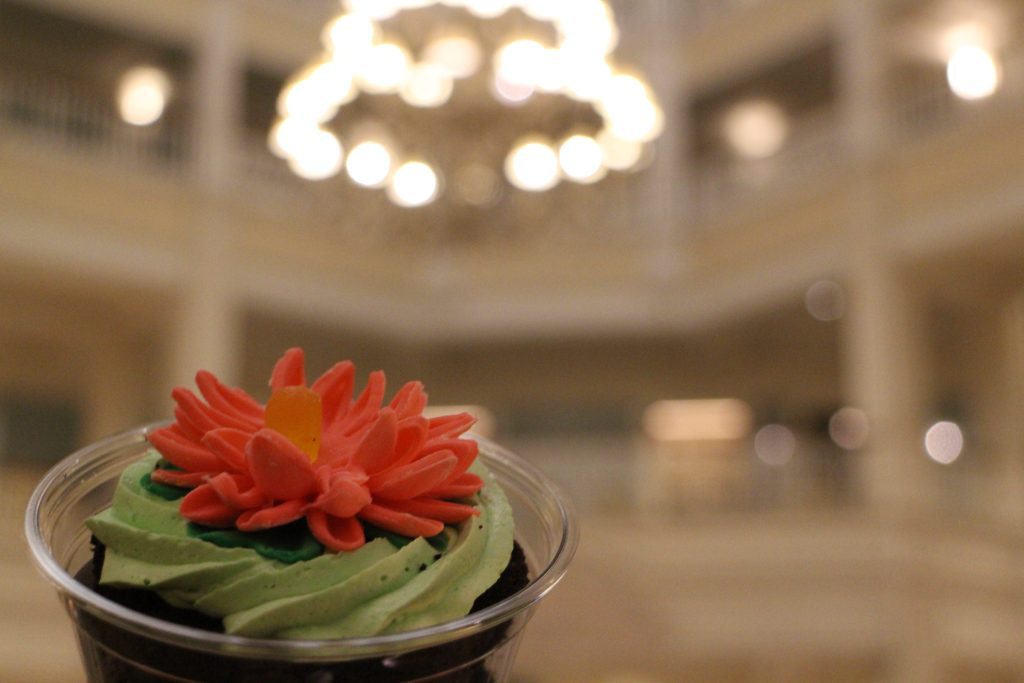 Grand Floridian Bunny Burrow Dirt Cup with green frosting and a pink flower on top.