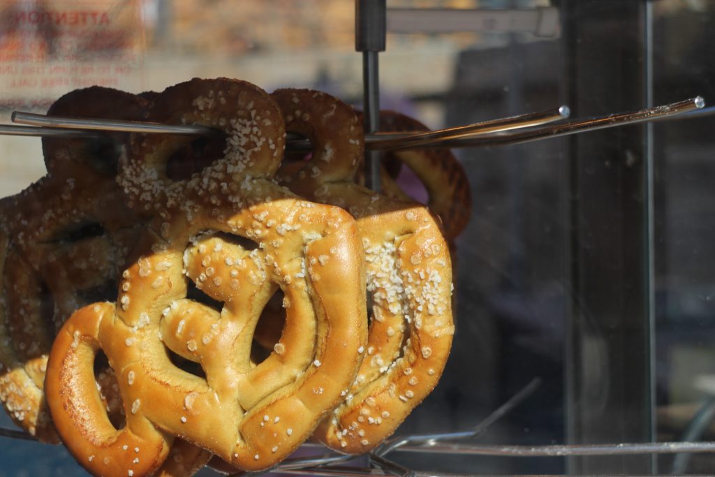 Mickey shaped pretzels hanging in a display.